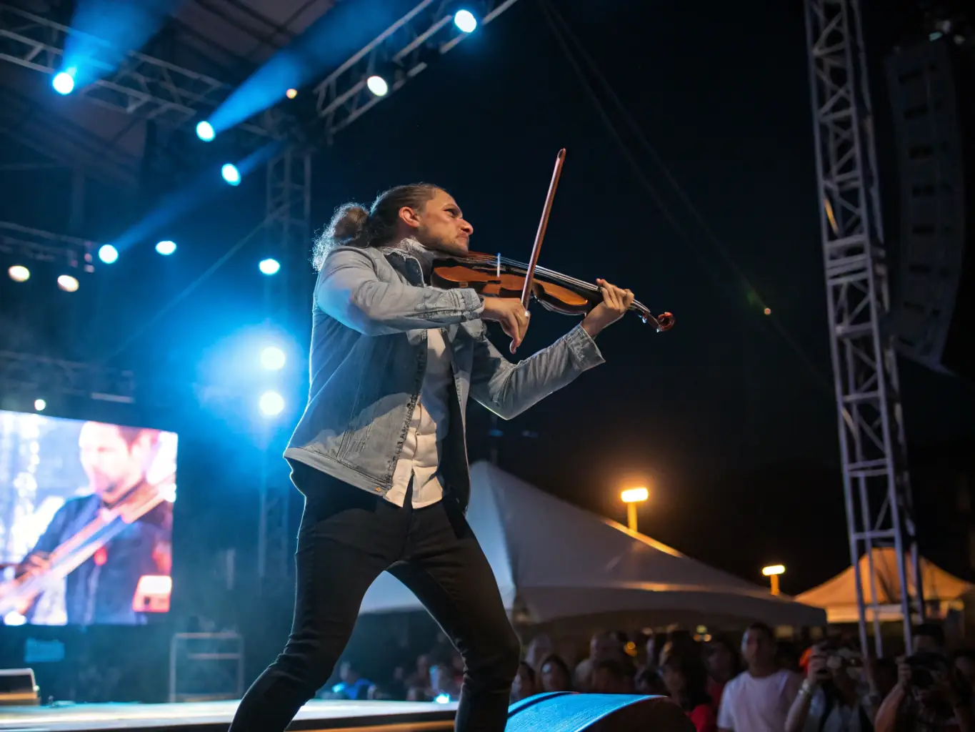 A musician playing a string instrument during a musical performance, capturing the emotion and artistry of the moment.